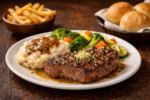 Center-Cut Sirloin Bundle featuring a juicy grilled sirloin steak served with mashed potatoes, vegetables, fries, and fresh dinner rolls